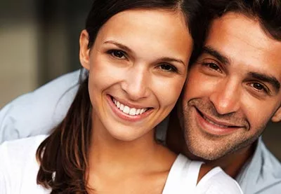 woman smiling with her husband after getting her teeth whitened in Laredo, TX